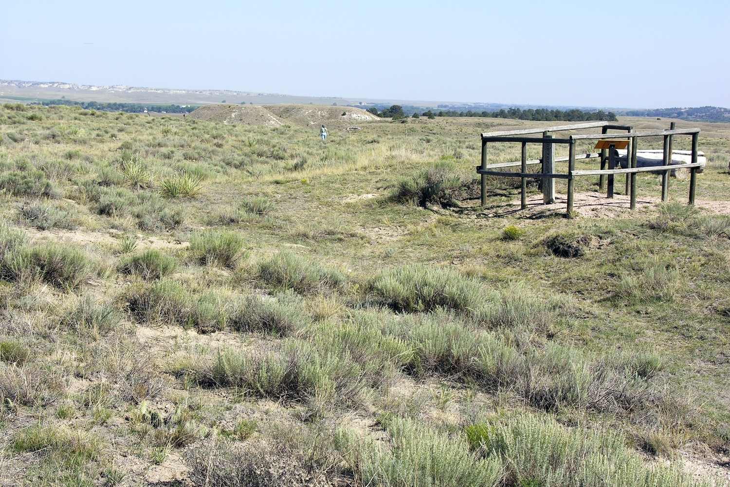 A fenced marker in the grass at the Bedlam ruts west of Fort Laramie.